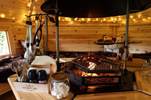 a kitchen with a grill with food on a counter at Scenery Hill Hideaways The Coach House Charming Retreat with Jacuzzi and BBQ Hut Near the Lake District in Workington