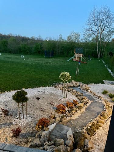 a garden with a park with a playground at Moje srećno mesto in Arandjelovac