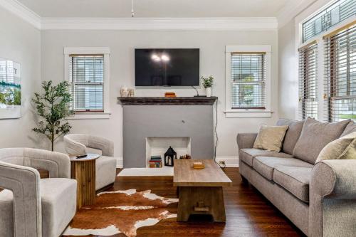 a living room with a couch and a fireplace at Fifth Street Retreat by StayLage in St. Charles