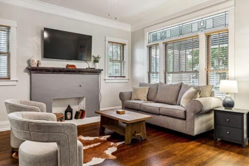 a living room with a couch and a fireplace at Fifth Street Retreat by StayLage in St. Charles