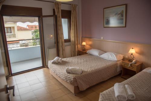 a hotel room with two beds and a window at studio nufaro in Mytilini