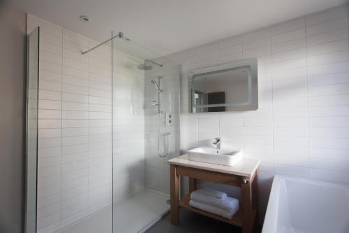 a white bathroom with a sink and a shower at Bosville Hotel in Portree