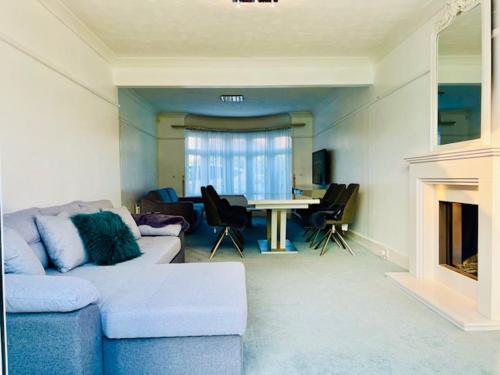 a living room with a blue couch and a table at Lilliput Village Canford Cliffs Salterns Marina&Harbour in Parkstone