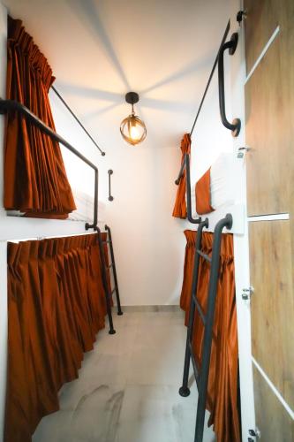 a dressing room with orange curtains and a ceiling at Qantic Lodging & Rooftop in Medellín