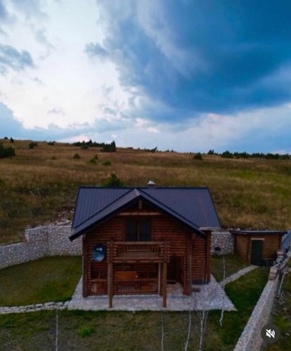 a log cabin in the middle of a field at LogCabin Žabljak in Žabljak