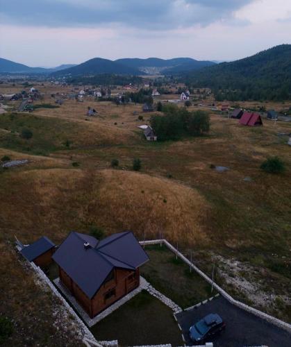an aerial view of a small house in a field at LogCabin Žabljak in Žabljak