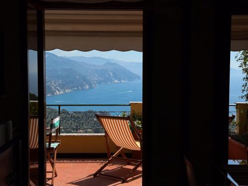 a balcony with chairs and a view of the ocean at Piccola Mares Rapallo in Rapallo