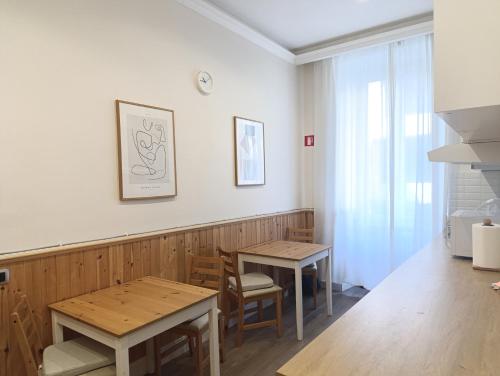 a dining room with two tables and a window at My Maison 109 Guest House in Rome