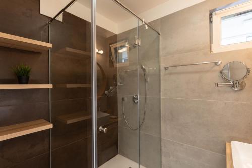 a shower with a glass door in a bathroom at Sunset Resort 217 in Fonyód