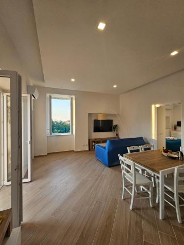 a living room with a blue couch and a table at Acquamarina in Sant'Agnello