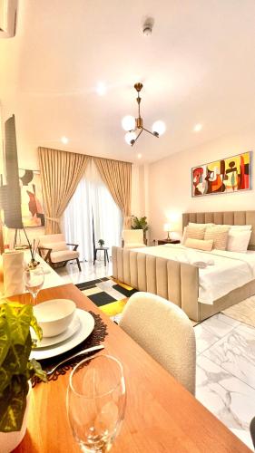 a large living room with a bed and a table at The Essence Studios, Accra Kotoka Airport in Accra