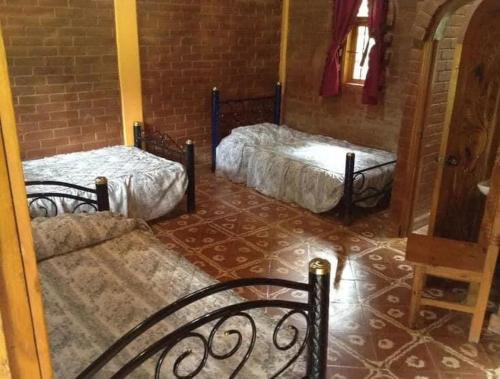 Ένα ή περισσότερα κρεβάτια σε δωμάτιο στο Shambala SPA Medicinal y Retiros