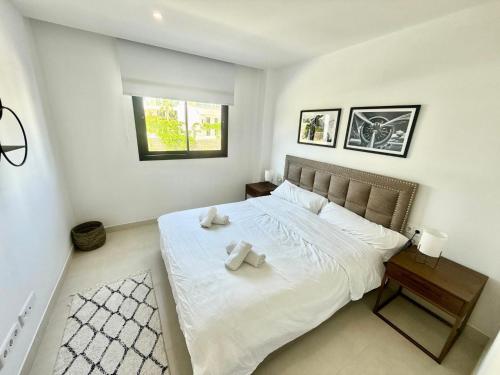 a bedroom with a bed with two towels on it at higuerón Aqualis in Torremuelle