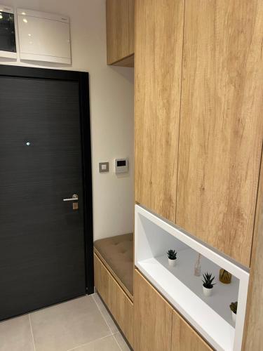 a room with a door and a bench next to a door at Ninth Cloud Apartman in Novi Sad