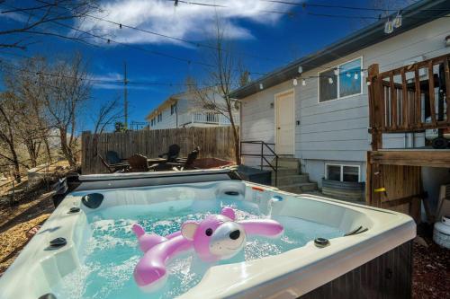 a hot tub with a pink toy in the water at Runaway Escapade! Hot Tub, BBQ & Fire Pit in Colorado Springs
