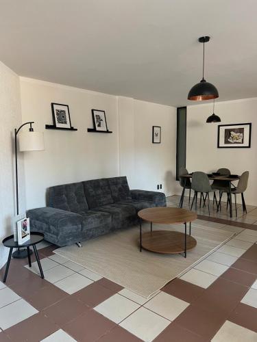 a living room with a couch and a table at 3 - Departamento amplio y centrico in Morelia