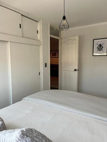 a bedroom with a large white bed in a room at 3 - Departamento amplio y centrico in Morelia