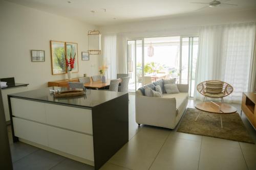 a living room with a couch and a table at O'Biches Beachfront Homes - Trou aux Biches in Trou aux Biches