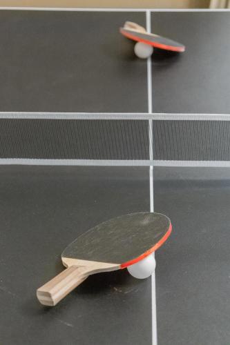 two skateboards are sitting on a tennis court at Pristine & Homely Getaway with 6pple hot tub in Richardson