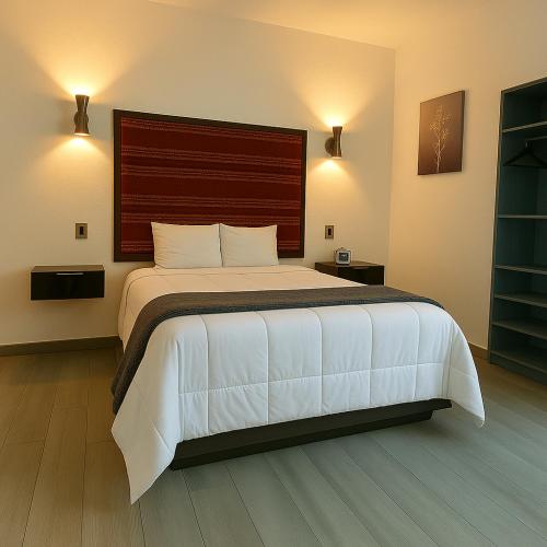 a bedroom with a large bed with a large headboard at YOEL Hotel Restaurante y Centro de Negocios in Atlacomulco de Fabela