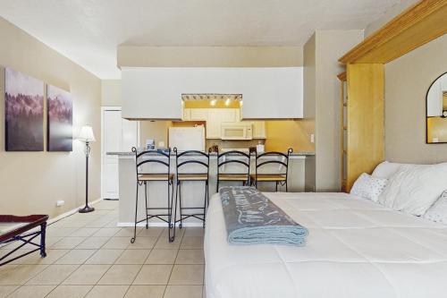 a room with a bed and a kitchen with a counter at Ski Run B1 in Angel Fire