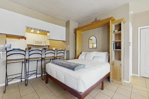 a bedroom with a bed and a kitchen with a bar at Ski Run B1 in Angel Fire