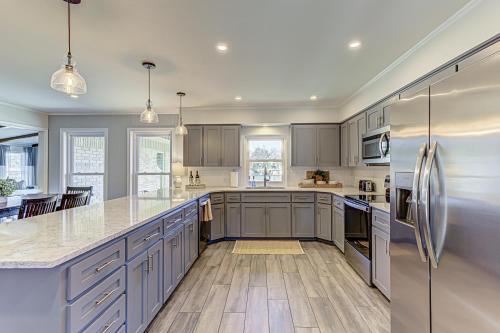 a kitchen with gray cabinets and stainless steel appliances at Two Docks on Riverside in Kingsland