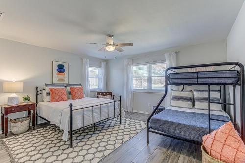 a bedroom with two bunk beds and a ceiling fan at Two Docks on Riverside in Kingsland