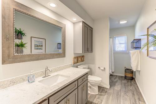 a bathroom with a sink and a toilet at Two Docks on Riverside in Kingsland