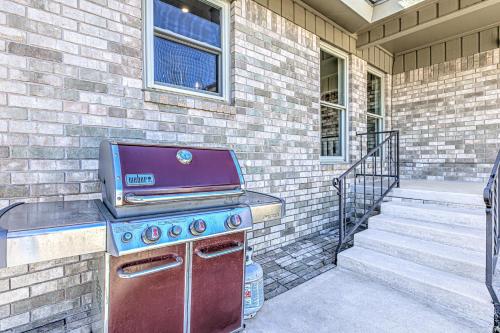 a barbecue grill sitting on the outside of a house at Two Docks on Riverside in Kingsland
