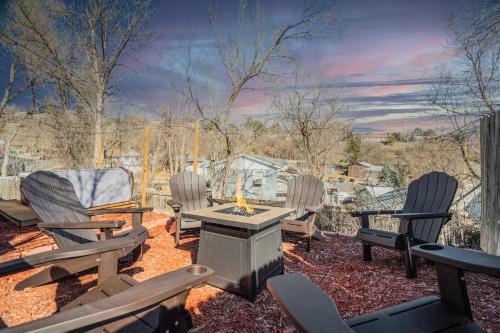 a group of chairs sitting around a fire pit at Runaway Escapade! Hot Tub, BBQ & Fire Pit in Colorado Springs
