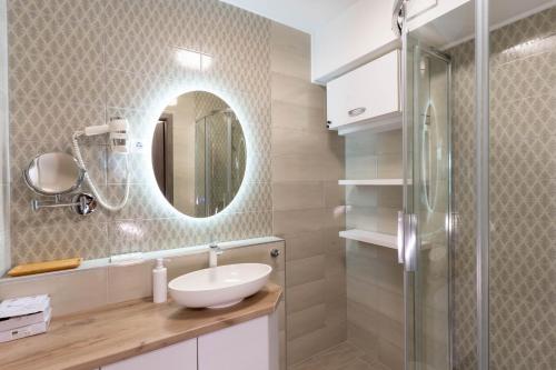 a bathroom with a sink and a mirror at Sunset Resort 103 in Fonyód