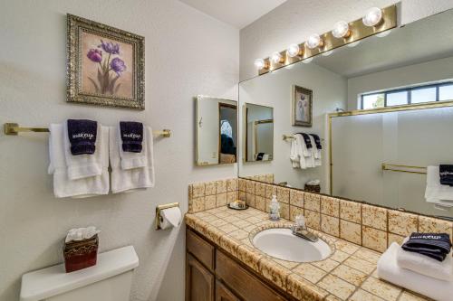 a bathroom with a sink and a mirror at Peaceful Groveland Home with Deck and Fire Pit! in Groveland