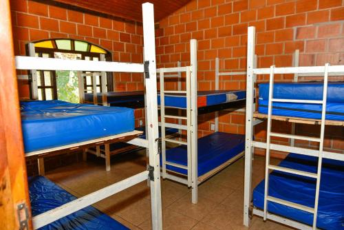 two bunk beds in a room with a brick wall at CHACARA HORTOLAN in Mairinque