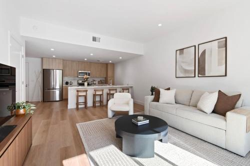 a living room with a couch and a table at Luxurious 2BR Apartment in heart of Silicon Valley in Santa Clara