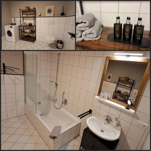 a bathroom with a bath tub and a sink at Holledauer Hopfakammerl in Wolnzach