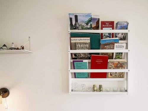 a book shelf on a wall with books at Modern Loft with Sea View - By Traum Ferienwohnungen in Allinge