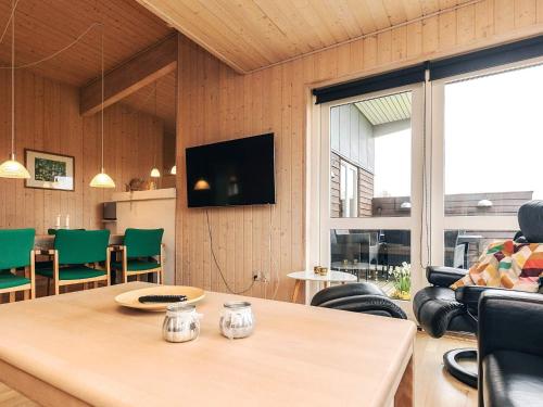 a living room with a table and a tv at Well-maintained holiday home in Faborg in Nabbe
