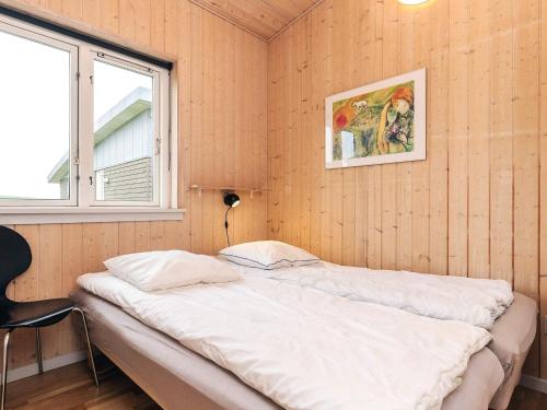 a bed in a room with a window at Well-maintained holiday home in Faborg in Nabbe
