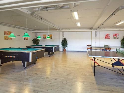 a room with pool tables and ping pong tables at 4 person holiday home on holiday park in Glesborg in Glesborg