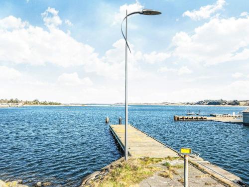 a street light on a dock on a body of water at 6 person holiday home in Højslev-By Traum in Højslev