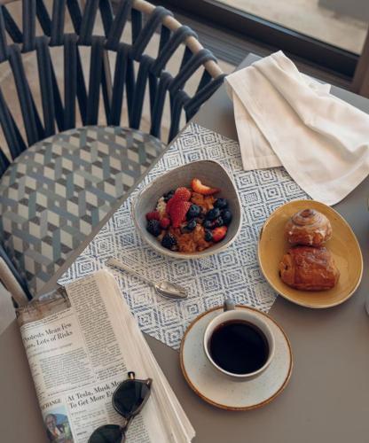 a table with two plates of food and a cup of coffee at Grand Velas Boutique Hotel in San José del Cabo