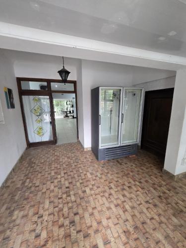 an empty room with a hallway with a glass door at Oasiselfcatering guest house in Vosburg