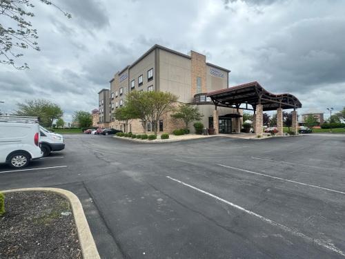 a parking lot with a car parked in front of a building at Sonesta Essential Indianapolis Airport in Plainfield