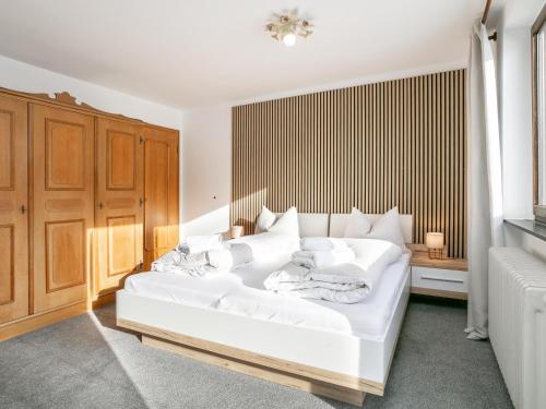 a bedroom with a white bed with white towels on it at Brixen Alpin Living Top 15 in Brixen im Thale