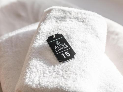 a black tag sitting on top of a white towel at Brixen Alpin Living Top 15 in Brixen im Thale