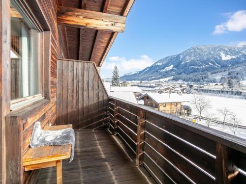 a balcony with a bench and a view of the mountains at Brixen Alpin Living Top 15 in Brixen im Thale