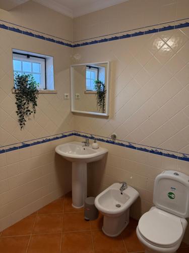a bathroom with a toilet and a sink at Breeze House Almograve - Casa de Férias T4 in Almograve
