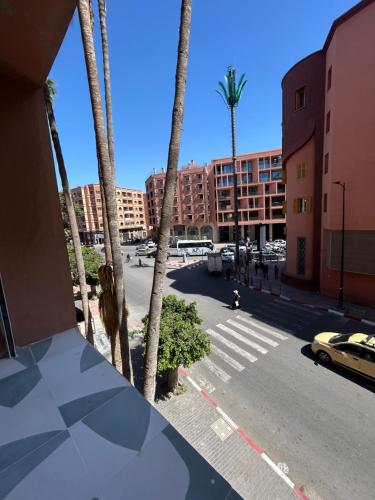 a view of a city street with palm trees at Eden Vibes GUELIZ in Marrakech