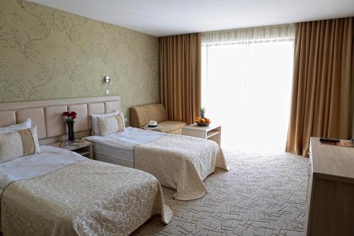 Postel nebo postele na pokoji v ubytování Hotel Spa Terma